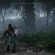 Aloy stands in a pathway in forest in Horizon Forbidden West on PS5.